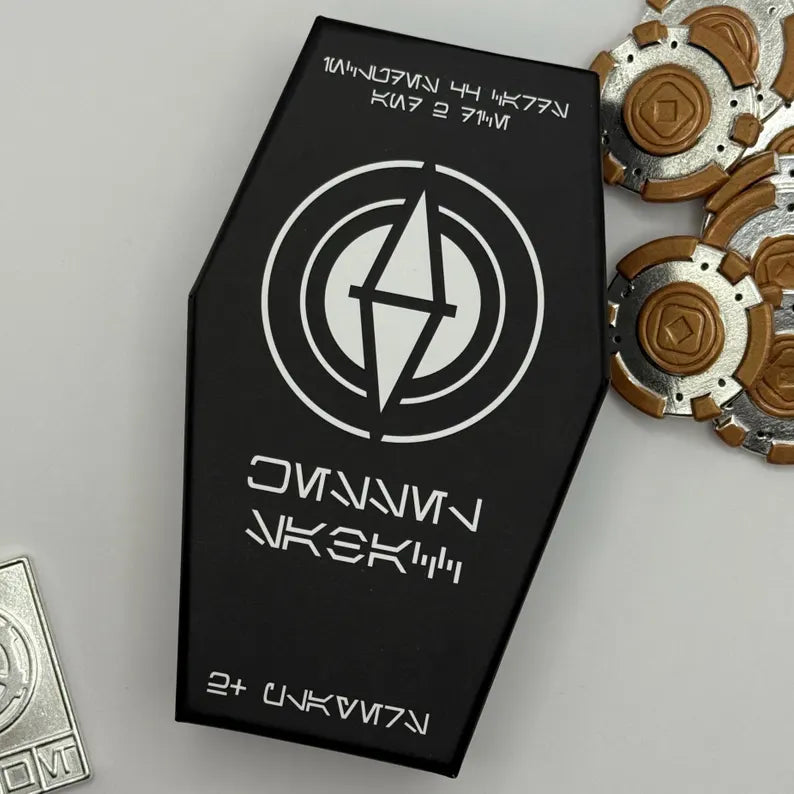 Star Wars-inspired playing card deck in a sleek black coffin-shaped box, featuring collectible game tokens and metallic credits. Perfect for fans and collectors. Limited edition Sabacc deck.