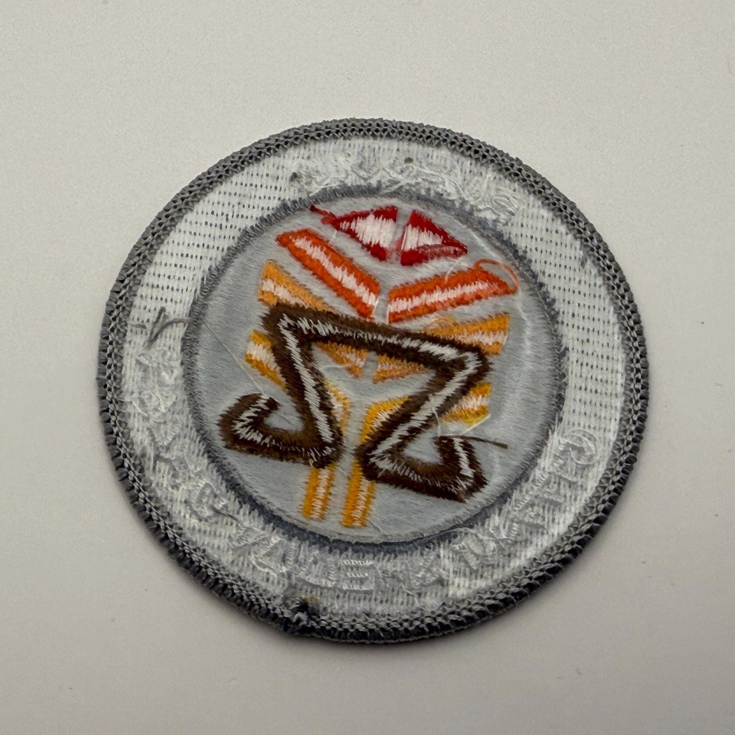 Iron-on backing of the At-Attin Middle School Gamma embroidered patch, displaying its secure and textured adhesive layer for easy application.